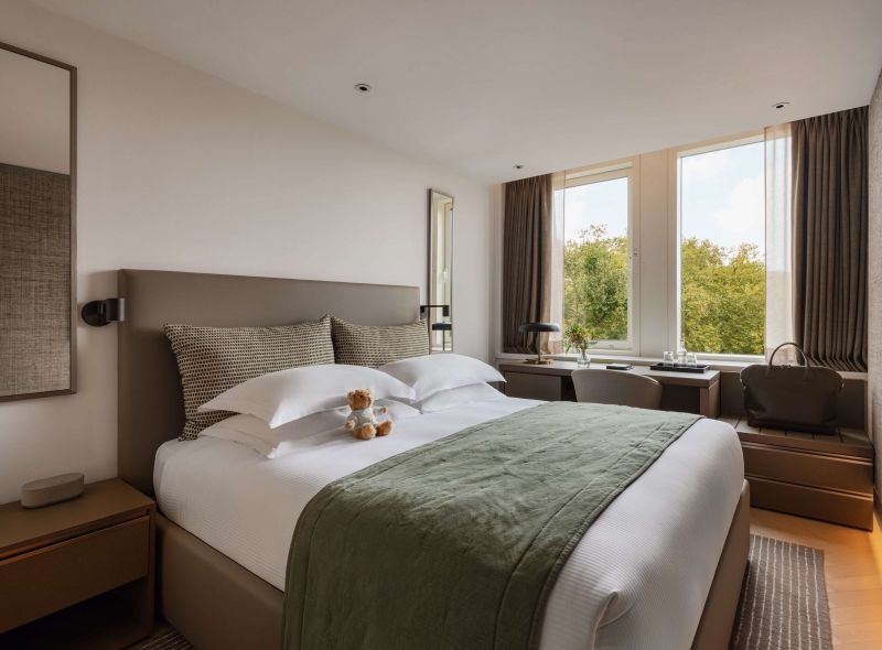 Royal Double Room at Royal Garden Hotel featuring a luxurious king bed, comfortable work desk and a view of the Kensington Gardens.