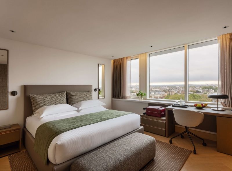 Deluxe Double Room at Royal Garden Hotel with luxurious king bed, comfortable work desk and a view of Kensington Gardens.