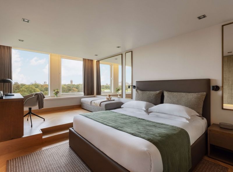 The newly refurbished Royal Garden Deluxe Room at Royal Garden Hotel features a lavish king bed, a comfortable work desk and sofa area, and a stunning view of Kensington Gardens from high floors.