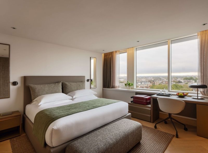 The spaciosu Deluxe Double Room at Royal Garden Hotel features a lavish King Bed, a comfortable work desk with a panoramic city view.