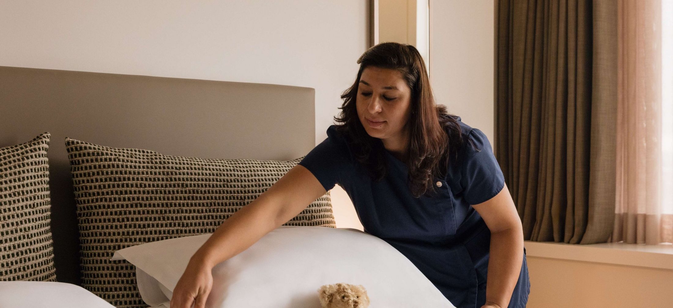 The attentive housekeeping team member at Royal Garden Hotel.