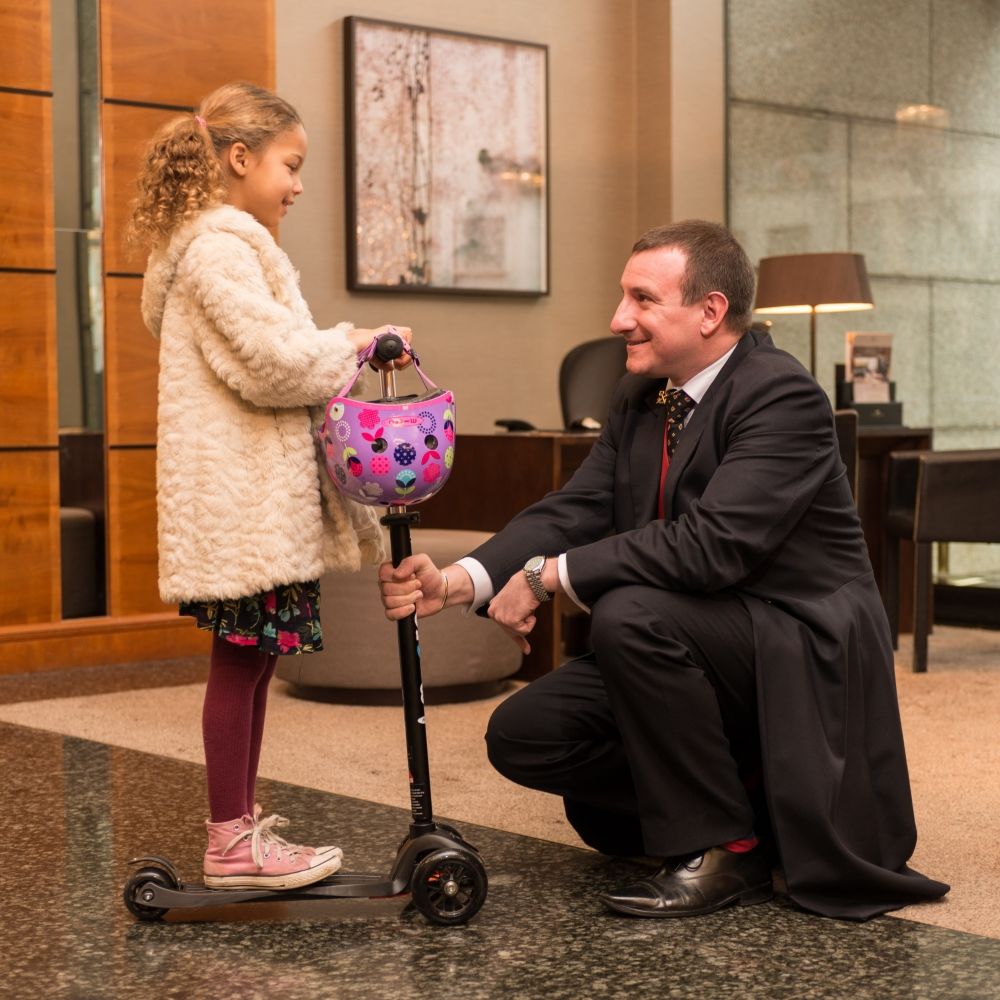 The concierge team at Royal Garden Hotel assisting with a little guest.